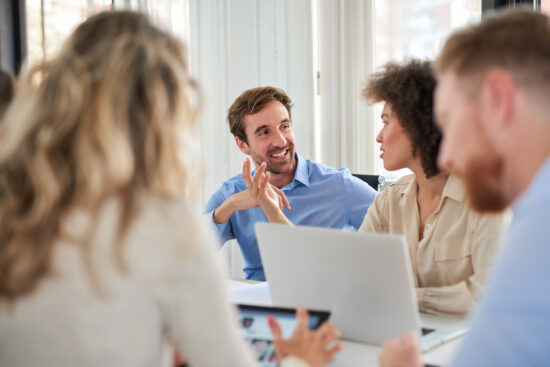 Colleagues sitting at meeting and chatting